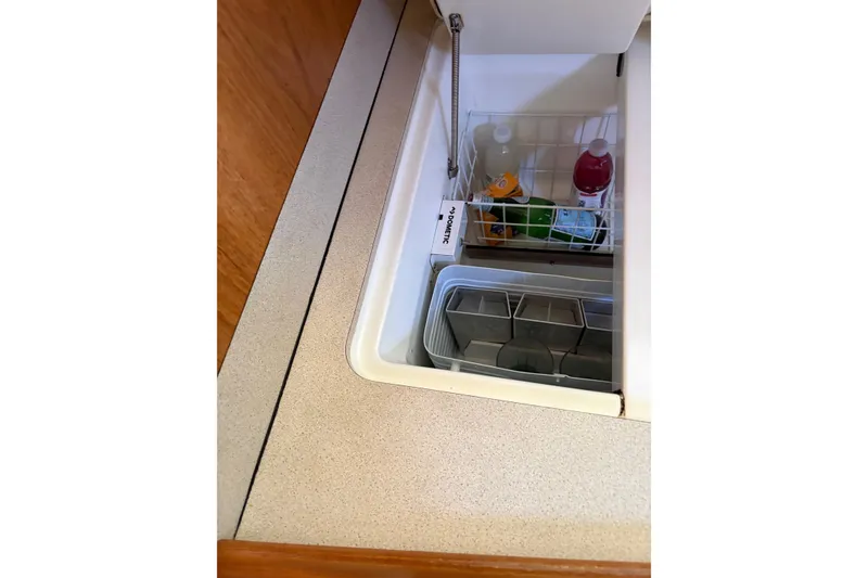 Slide: The Image of Built-in fridge on 2001 Jeanneau Sun Odyssey 45.2 yacht, stocked with beverages. - 20
