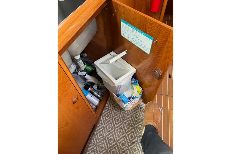 Slide: The Image of Interior of 2001 Jeanneau Sun Odyssey 45.2 yacht showing storage and waste bin. - 21