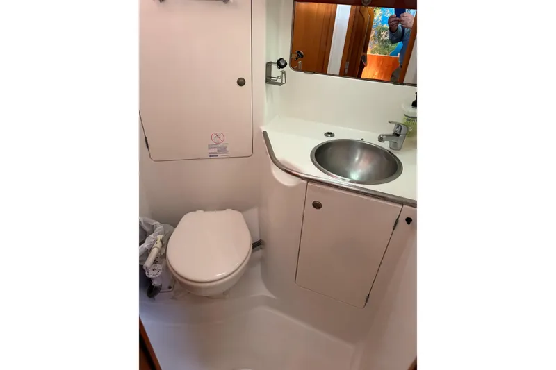 Slide: The Image of Bathroom interior of 2001 Jeanneau Sun Odyssey 45.2 yacht, featuring toilet and sink. - 23
