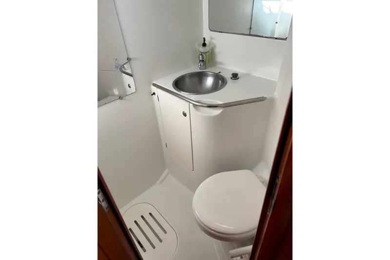 Slide: The Image of Compact bathroom in 2001 Jeanneau Sun Odyssey 45.2 yacht, featuring sink and toilet. - 24