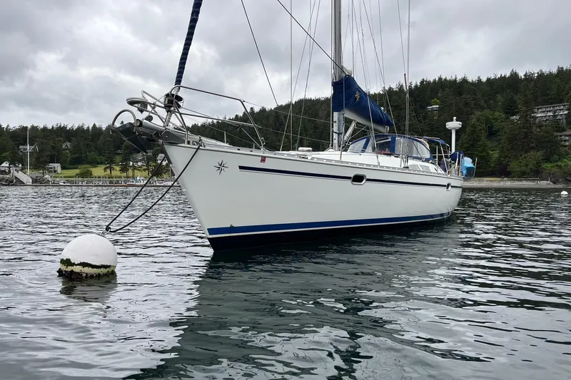 Slide: The Image of 2001 Jeanneau Sun Odyssey 45.2 sailboat moored on calm water, overcast sky. - 27