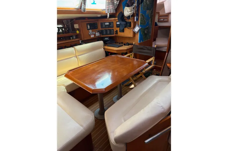Slide: The Image of Interior of 2001 Jeanneau Sun Odyssey 45.2 yacht with wooden table and beige seating. - 3