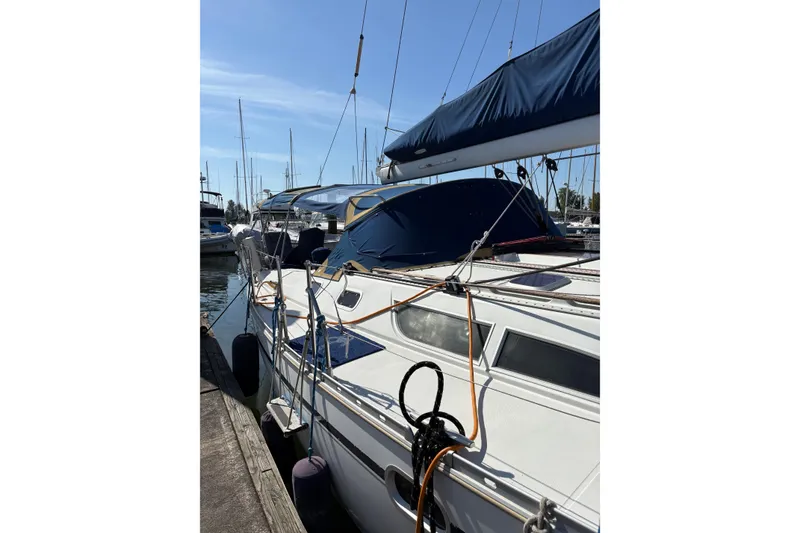 Slide: The Image of 2001 Jeanneau Sun Odyssey 45.2 sailboat docked at marina under clear blue sky. - 32