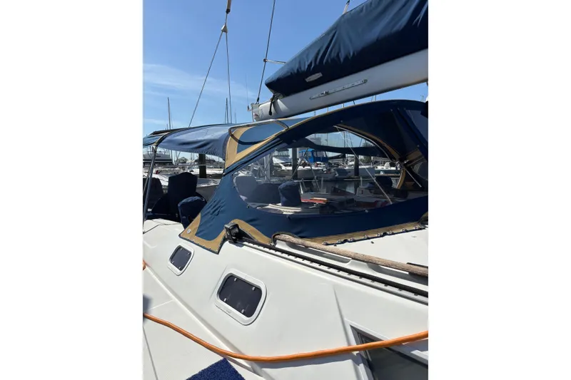 Slide: The Image of 2001 Jeanneau Sun Odyssey 45.2 sailboat with blue canopy in marina setting. - 33