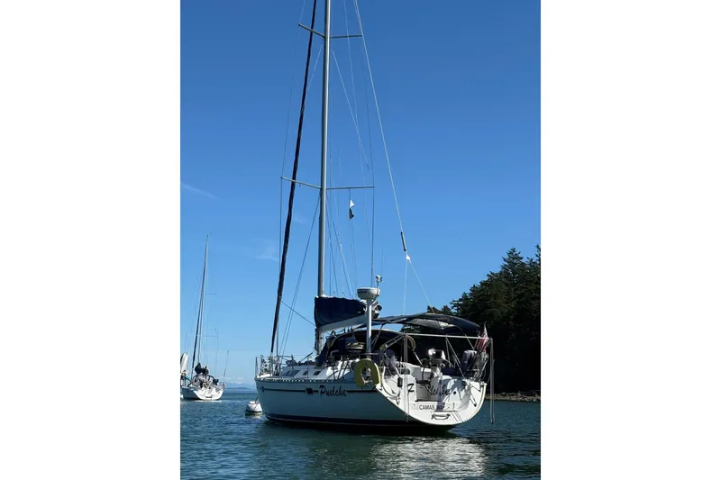 Slide: The Image of 2001 Jeanneau Sun Odyssey 45.2 sailboat anchored on calm water under clear blue sky. - 36