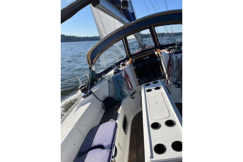 Slide: The Image of 2001 Jeanneau Sun Odyssey 45.2 sailboat cockpit with ropes and seating on a sunny day. - 38