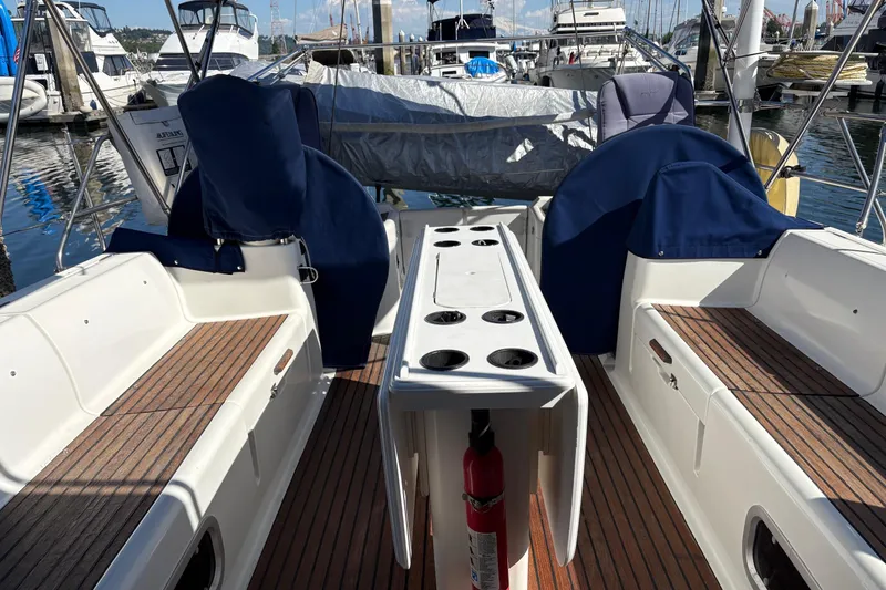 Slide: The Image of Cockpit of 2001 Jeanneau Sun Odyssey 45.2 sailboat with seating and covered steering wheels. - 40