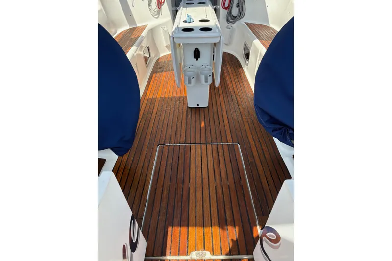Slide: The Image of Teak deck of 2001 Jeanneau Sun Odyssey 45.2 sailboat cockpit, featuring seating and storage. - 41
