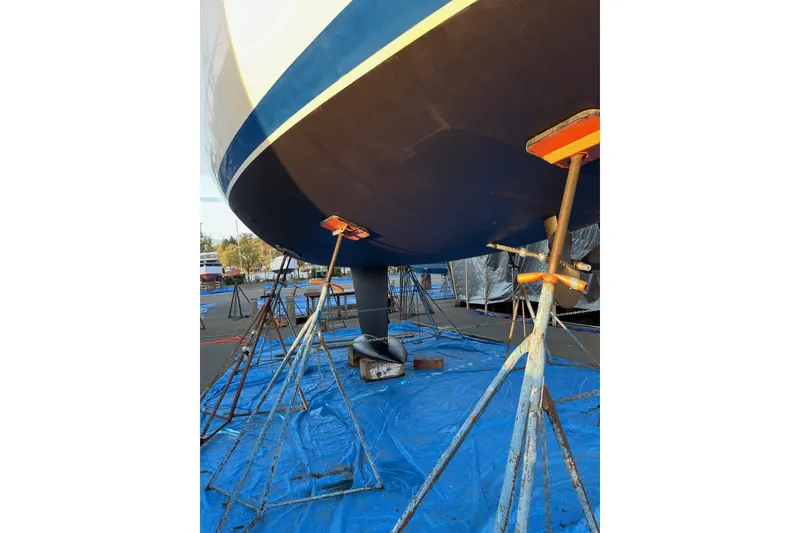 Slide: The Image of Jeanneau Sun Odyssey 45.2 sailboat hull on stands, 2001 model, in dry dock. - 43