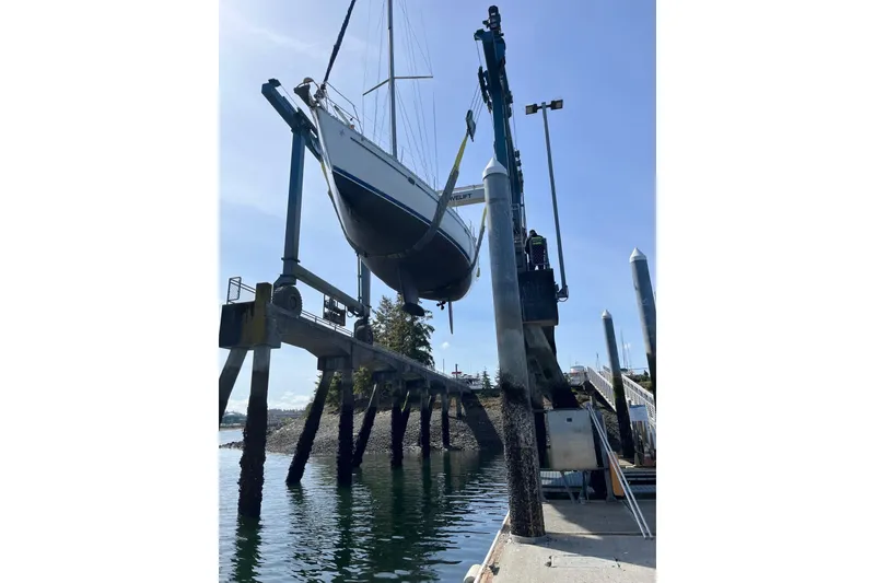 Slide: The Image of Jeanneau Sun Odyssey 45.2 sailboat being lifted at a marina, 2001 model. - 45