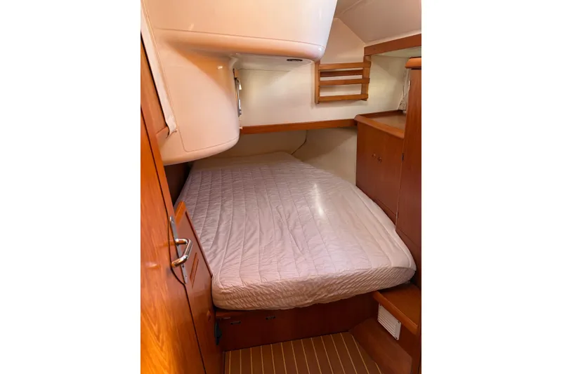 Slide: The Image of Cozy cabin interior of 2001 Jeanneau Sun Odyssey 45.2 sailboat with wooden furnishings. - 8
