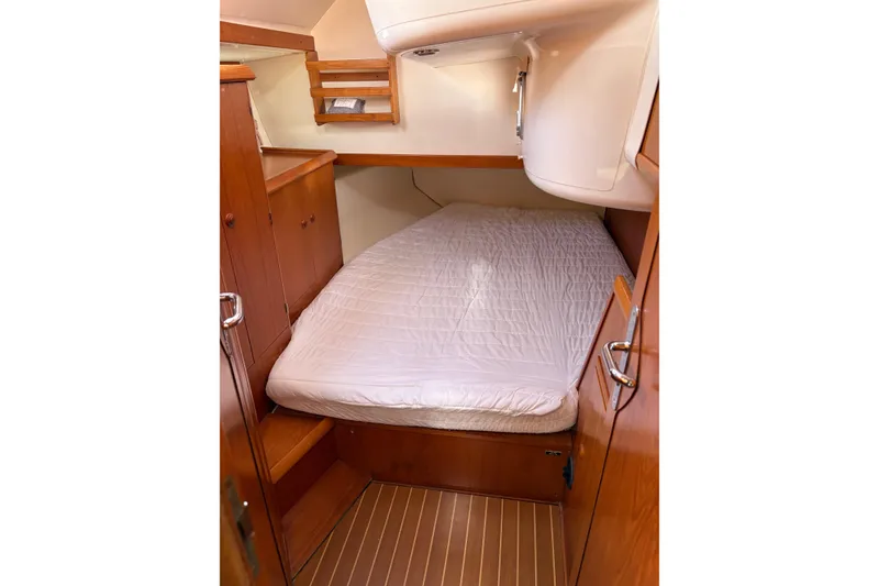 Slide: The Image of Cozy cabin interior of 2001 Jeanneau Sun Odyssey 45.2 sailboat with wooden furnishings. - 9