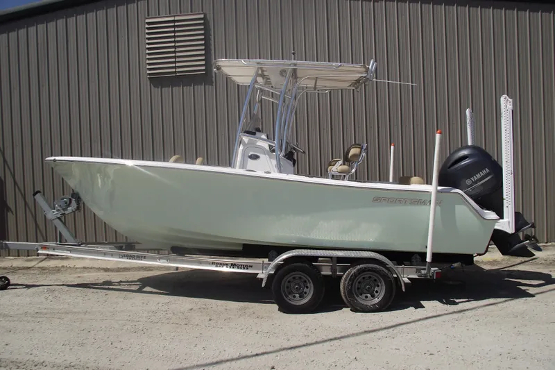 The Image of 2016 Sportsman Open 212 Center Console boat on trailer, parked outdoors. - 0
