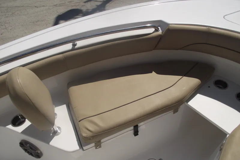 Slide: The Image of 2016 Sportsman Open 212 Center Console boat seating area with beige cushions. - 10