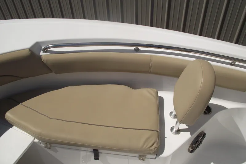 Slide: The Image of 2016 Sportsman Open 212 Center Console boat with tan cushioned seating. - 11