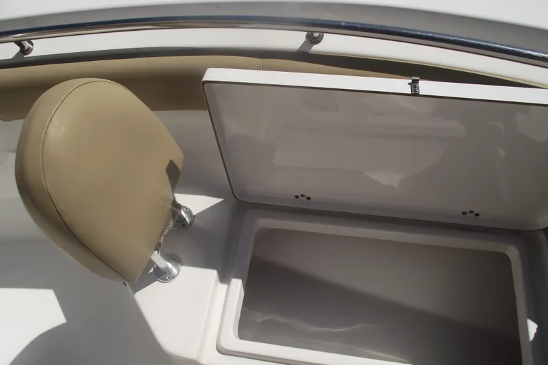 Slide: The Image of 2016 Sportsman Open 212 Center Console boat storage compartment and seat detail. - 12