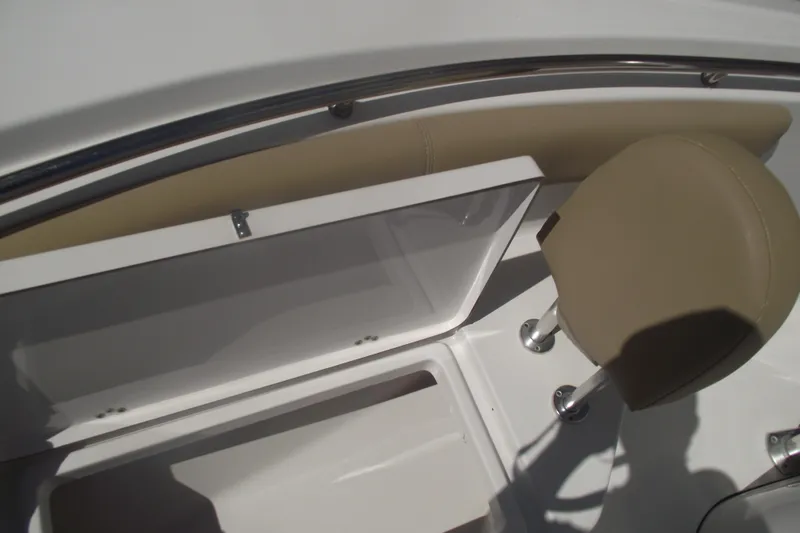 Slide: The Image of 2016 Sportsman Open 212 Center Console interior with storage compartment and seating. - 13
