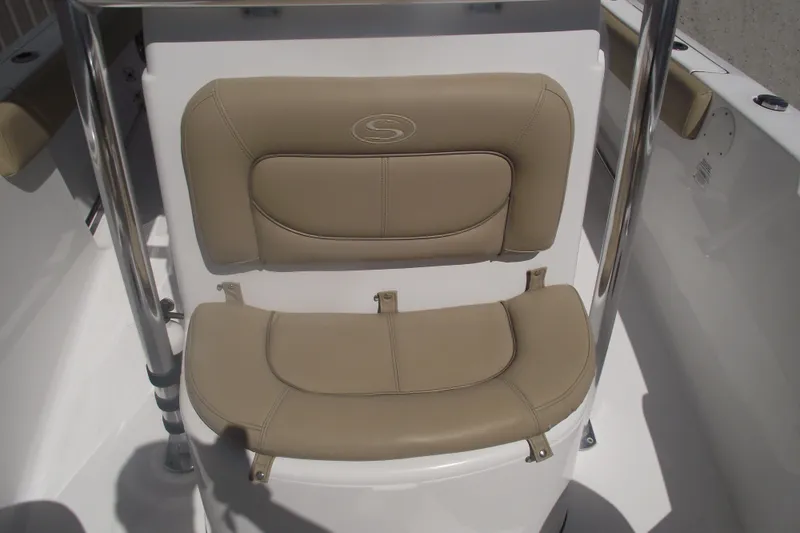 Slide: The Image of 2016 Sportsman Open 212 Center Console boat seat with tan cushions and stainless steel frame. - 14