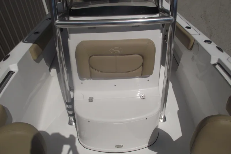 Slide: The Image of 2016 Sportsman Open 212 Center Console boat interior with beige seating and stainless steel railings. - 15