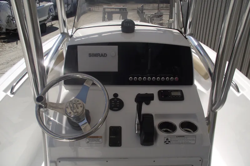 Slide: The Image of 2016 Sportsman Open 212 Center Console dashboard with steering wheel and Simrad display. - 17