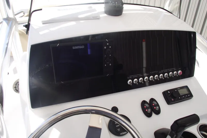 Slide: The Image of 2016 Sportsman Open 212 Center Console dashboard with Simrad display and control panel. - 18