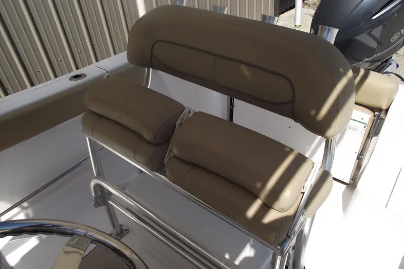 Slide: The Image of 2016 Sportsman Open 212 Center Console boat seating with tan cushions and stainless steel frame. - 20