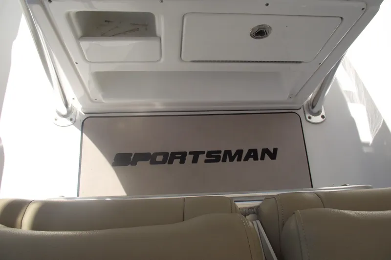 Slide: The Image of 2016 Sportsman Open 212 Center Console boat interior with logo mat and storage compartments. - 22