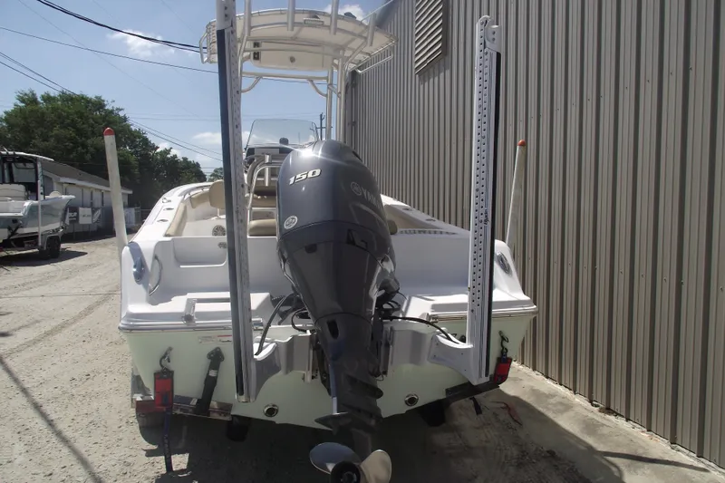Slide: The Image of 2016 Sportsman Open 212 Center Console boat with Yamaha 150 engine, parked outdoors. - 3