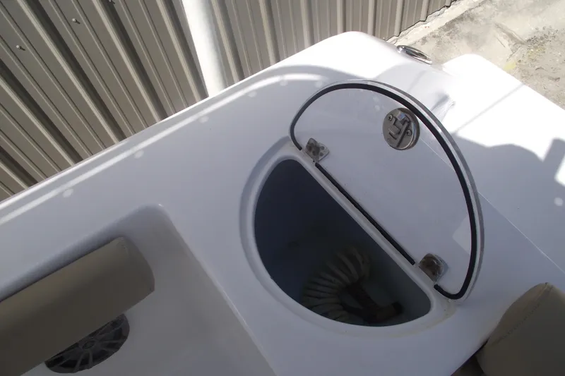 Slide: The Image of 2016 Sportsman Open 212 Center Console boat storage compartment with open hatch. - 31