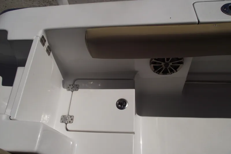 Slide: The Image of 2016 Sportsman Open 212 Center Console boat interior with storage compartment and speaker. - 32