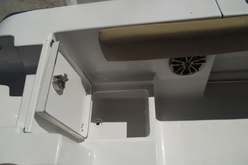 Slide: The Image of 2016 Sportsman Open 212 Center Console boat interior with storage compartment and speaker. - 33