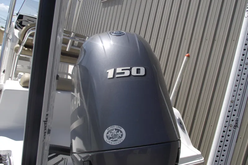 Slide: The Image of 2016 Sportsman Open 212 Center Console with Yamaha 150 engine, docked near metal siding. - 4