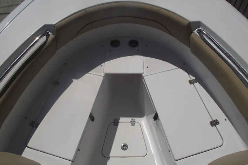 Slide: The Image of 2016 Sportsman Open 212 Center Console boat interior with cushioned seating and storage compartments. - 8