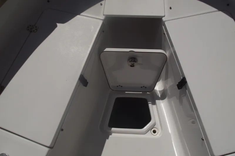 Slide: The Image of 2016 Sportsman Open 212 Center Console boat storage compartment, open hatch view. - 9
