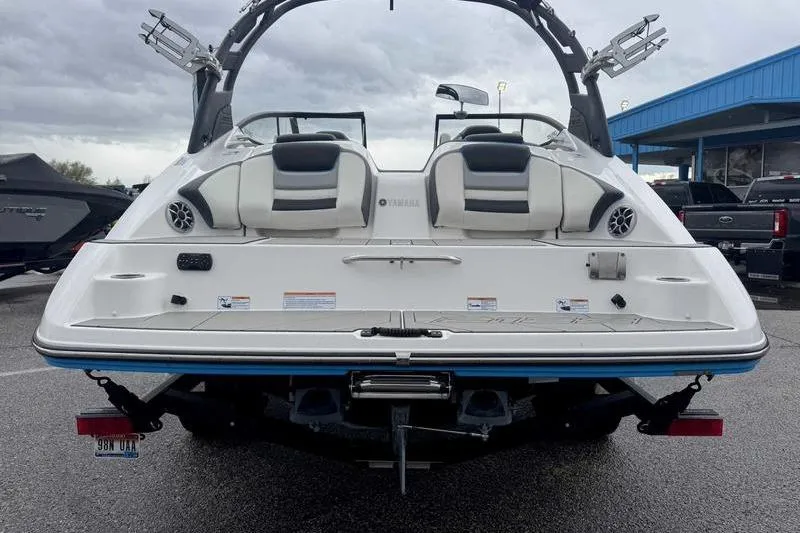 Slide: The Image of 2021 Yamaha Boats 212X rear view, showcasing sleek design and seating arrangement. - 10