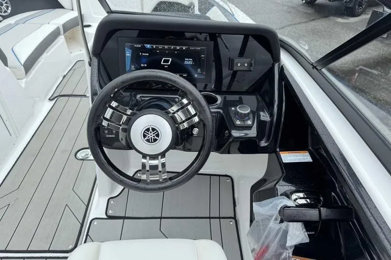 Slide: The Image of 2021 Yamaha Boats 212X dashboard with steering wheel and digital display. - 6