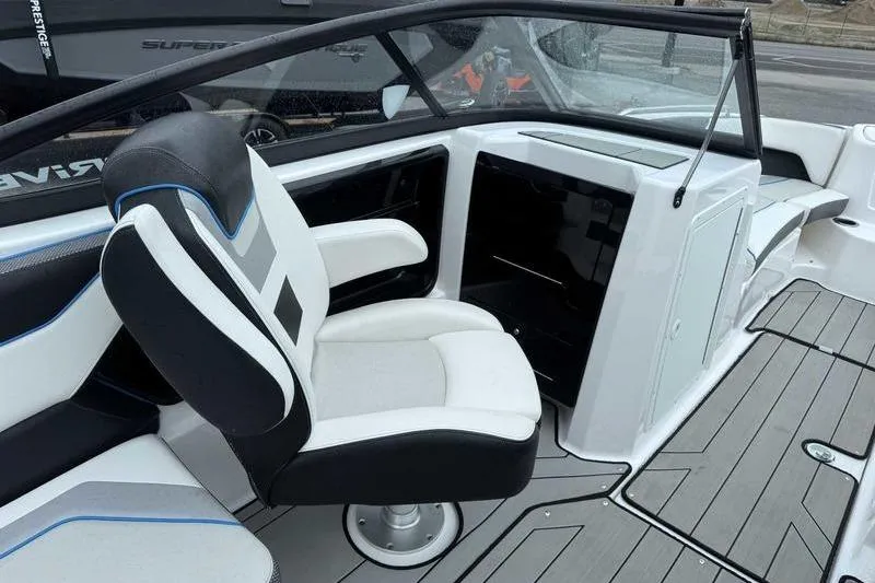 Slide: The Image of 2021 Yamaha Boats 212X interior with sleek seating and modern dashboard design. - 8