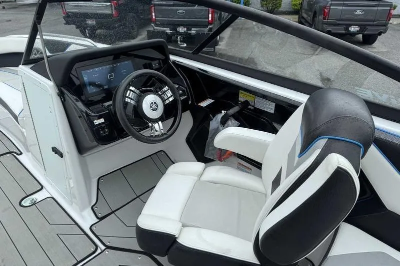 Slide: The Image of 2021 Yamaha Boats 212X cockpit with steering wheel and captain's chair, showcasing modern design. - 9