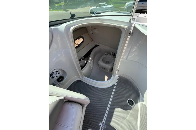 Slide: The Image of 2006 Crownline 252 EX boat interior with compact restroom and sleek design. - 4