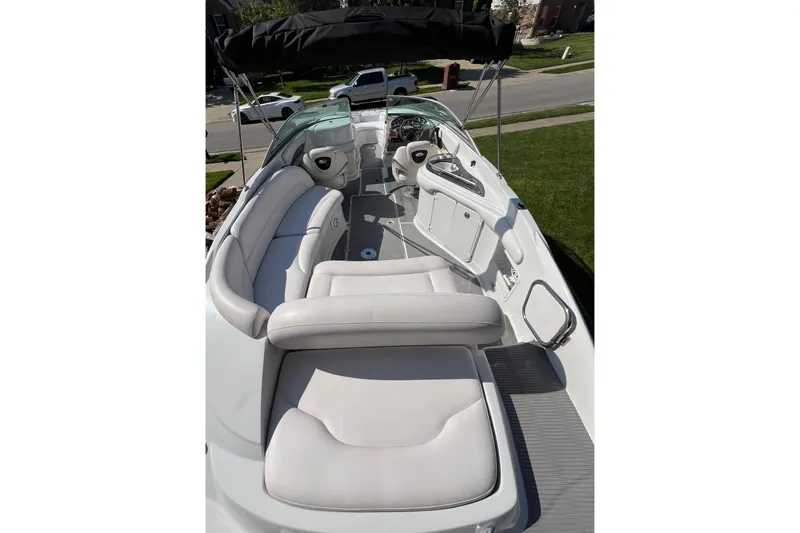 Slide: The Image of 2006 Crownline 252 EX boat interior with white seating and steering console. - 7