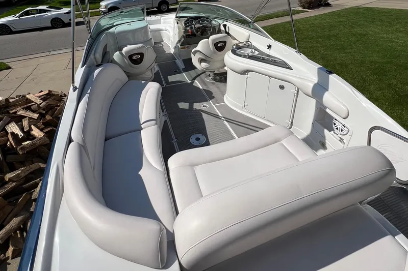 Slide: The Image of 2006 Crownline 252 EX boat interior with white seating and steering console. - 9