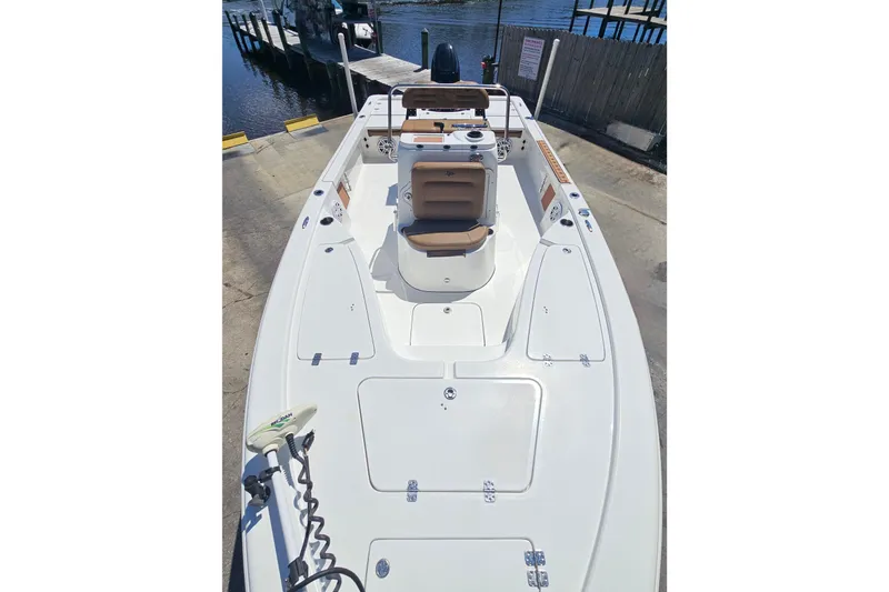 Slide: The Image of 2019 Sea Pro 208 Bay boat docked, showcasing spacious deck and seating. - 10