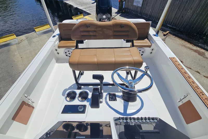 Slide: The Image of 2019 Sea Pro 208 Bay boat interior with steering wheel and seating. - 13