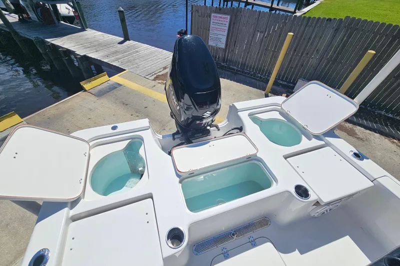 Slide: The Image of 2019 Sea Pro 208 Bay boat with open storage compartments at dockside. - 14