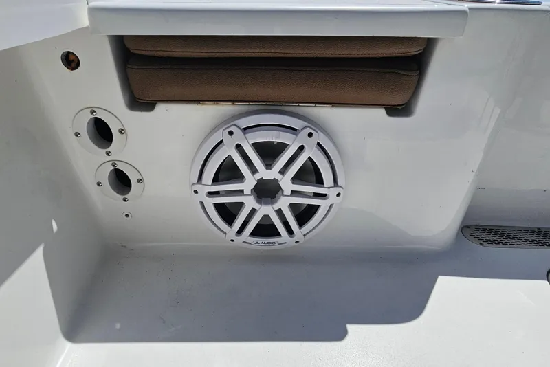 Slide: The Image of 2019 Sea Pro 208 Bay boat interior with JL Audio speaker and storage compartment. - 16