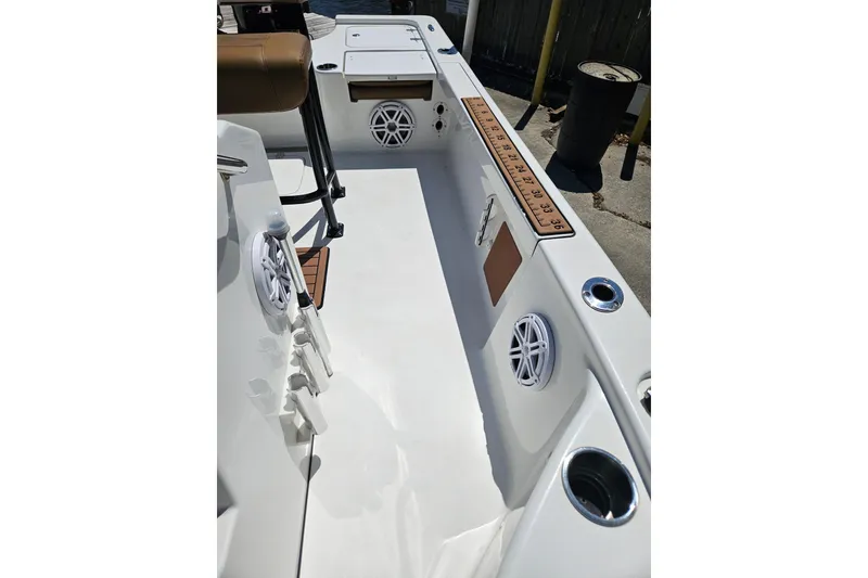 Slide: The Image of 2019 Sea Pro 208 Bay boat interior with rod holders and speakers. - 22