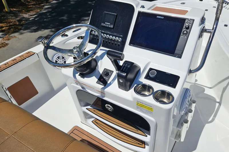 Slide: The Image of 2019 Sea Pro 208 Bay boat console with steering wheel and navigation controls. - 23
