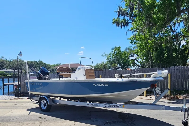 Slide: The Image of 2019 Sea Pro 208 Bay boat on trailer, parked near a waterfront. - 6