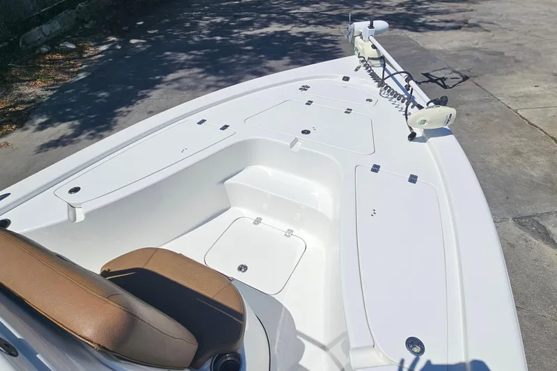 Slide: The Image of 2019 Sea Pro 208 Bay boat deck with seating and storage compartments. - 8
