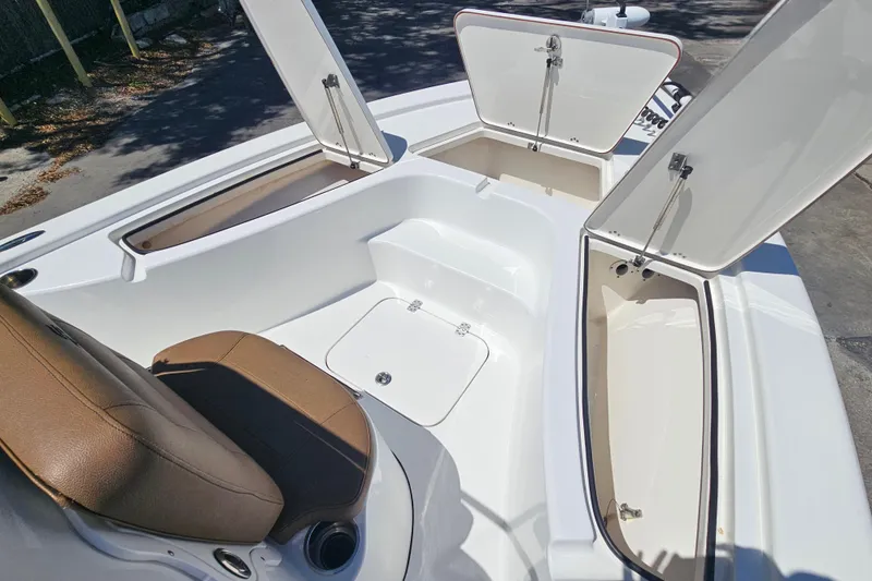 Slide: The Image of 2019 Sea Pro 208 Bay boat interior with open storage compartments and seating. - 9